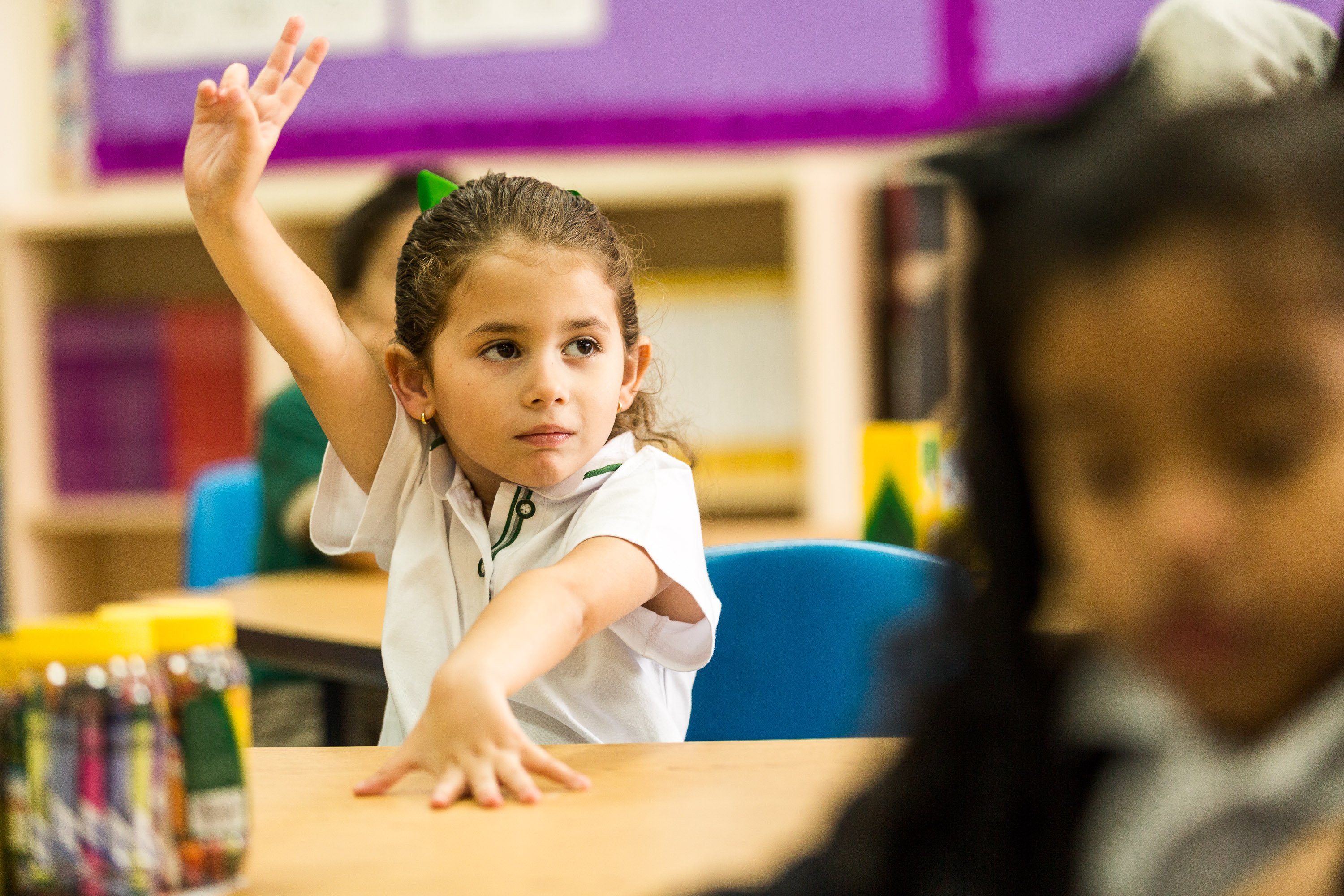 Girl raising hand in class